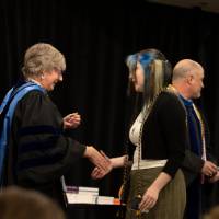 Student and Faculty shaking hands